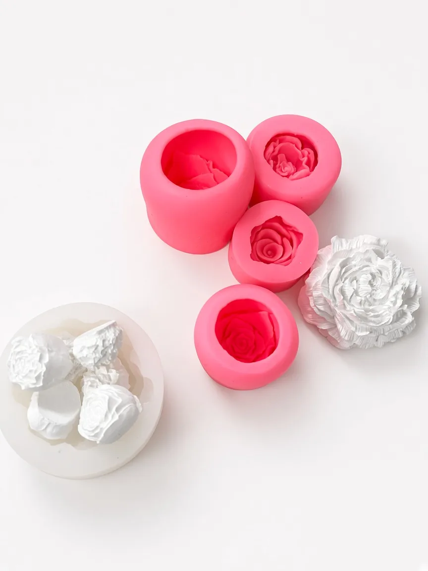 Pink silicone rose-cavity cups and a white floral master on a bench